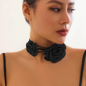 Detail of elegant double black 3D fabric rose choker with long ribbon ties on neck