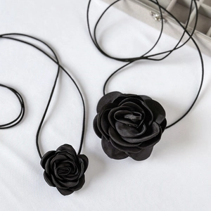 Detailed comparison of large and small black satin rose chokers with elegant long straps