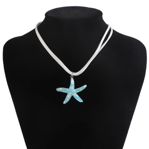 Blue resin starfish pendant on white velvet cord shown on a black mannequin