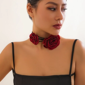 Close-up of a burgundy satin rose choker with multi-layer ties on a female model's neck