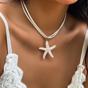 Bohemian white starfish pendant necklace featuring a double-strand cord on a lace top