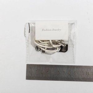 Detailed view of bohemian seashell necklace with adjustable silver clasp and scale reference