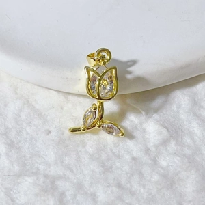 Elegant gold tulip pendant with sparkling zircon floral design on white ceramic base
