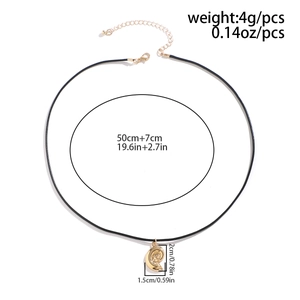 Golden snail pendant necklace dimensions and weight on a minimalist black wax cord