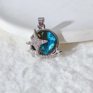 Detailed macro view of a silver celestial star pendant with blue opal nebula design