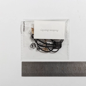 Detail of bohemian starfish pendant necklace with black cord and gold clasp packaging