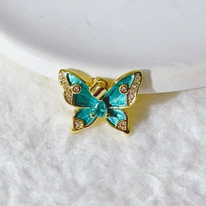Elegant gold butterfly pendant with turquoise enamel inlay and sparkling zircon crystals