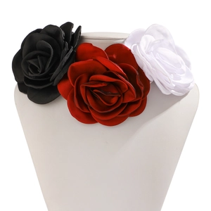 Detailed close-up of handmade fabric rose chokers in black, red, and white colors