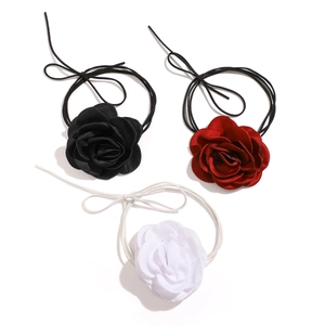 Detailed view of satin rose chokers in black, red, and white with long ribbon ties