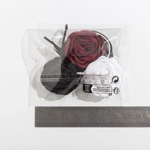 Three 3D fabric rose chokers in burgundy, black, and white with measurement ruler detail