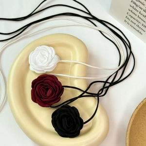 Detailed set of fabric rose chokers in white, burgundy, and black with long thin straps