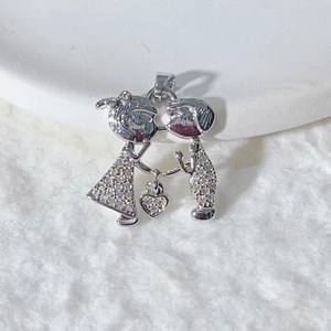 Detail of silver Cupid arrow pendant with micro-paved zircons on a white plush background