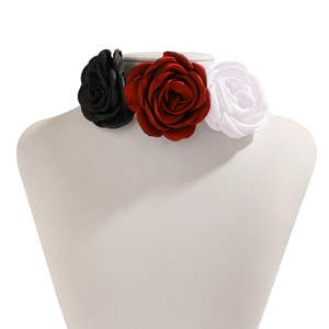 Detail of silk rose choker featuring black, red, and white flowers on a neck mannequin