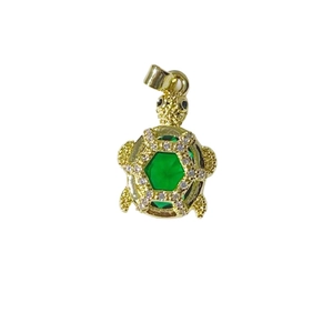 Gold sea turtle pendant with a hexagonal green gemstone and sparkling zircon accents