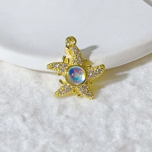 Starfish pendant in gold-plated steel with white crystals and opal center stone