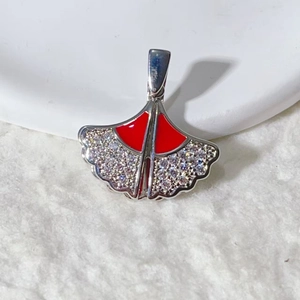 Elegant ginkgo leaf pendant with red enamel and pavé rhinestones on soft white texture