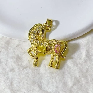 Macro detail of horse pendant in gold plating with pavé cubic zirconia and gemstones
