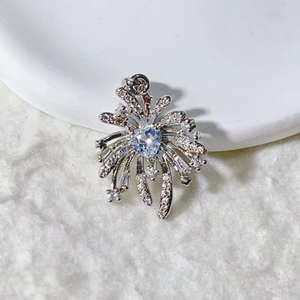 Macro shot of starburst pendant with heart-shaped blue stone and pave crystals