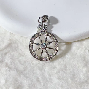 Macro shot of silver ship wheel charm with crown top and micro-set cubic zirconia