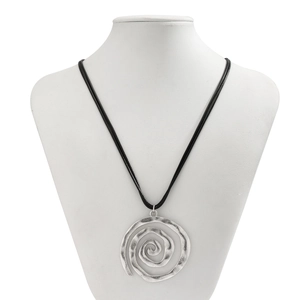 Detail of vintage silver spiral seashell pendant on black cord shown on a white mannequin