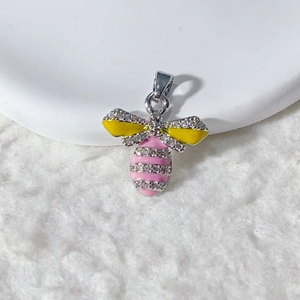 Detail view of silver bee pendant with yellow enamel wings and pink zircon accents