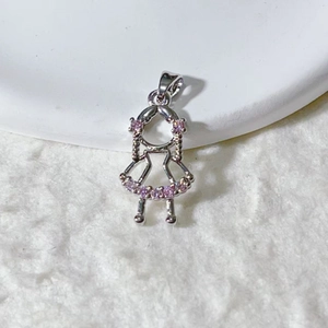 Macro detail of silver girl pendant with pink zircon inlay for DIY jewelry design