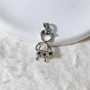 Detailed view of silver girl pendant with black zircon inlays on white display