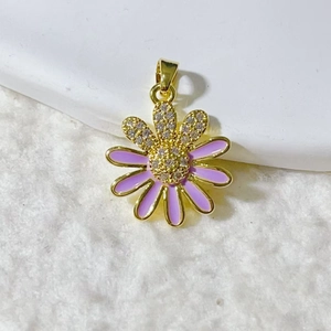 Macro detail of purple enamel daisy pendant with gold plating and zircon inlay