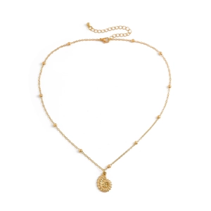 Close-up of golden conch shell pendant and beaded chain for beach jewelry aesthetic