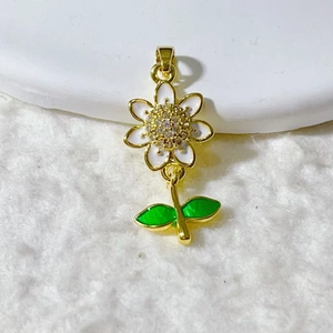 Daisy flower charm with gold plating and white enamel petals featuring tiny cubic zirconia