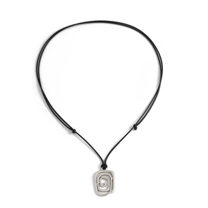 Macro detail of silver geometric spiral pendant on adjustable black cord necklace