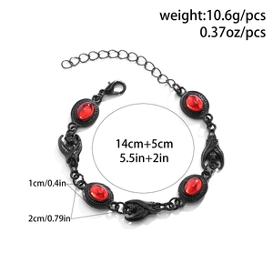 Gothic bat bracelet detail with red gemstone and adjustable chain measurements