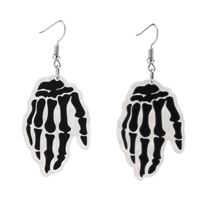 Detail of acrylic Halloween earrings featuring black and white skeleton hand pendants