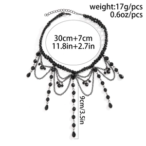 Close-up of black gothic choker necklace showing bead chains and teardrop pendant details
