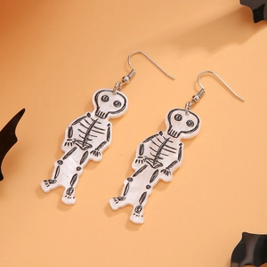 Close-up of white acrylic skeleton earrings on an orange background with bat silhouettes