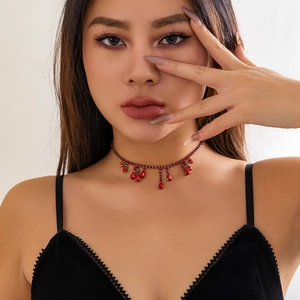 Close-up of gothic red crystal choker with blood-drop tassels for Halloween