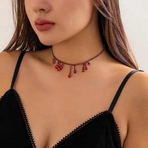 Detailed view of Gothic red crystal blood drip choker necklace on a female model neck