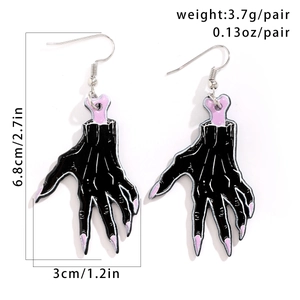 Detail view of skeleton hand earrings with purple nails and precise measurements