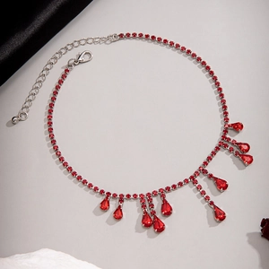 Detailed view of red crystal water drop fringe on a gothic choker with silver metal base