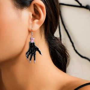 Gothic black ghost hand earrings with purple detail worn by model for Halloween