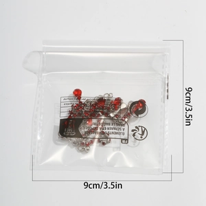 Detail of red crystal drop choker in a clear poly bag with size marking 9cm