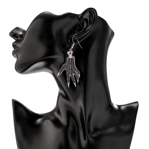 Close-up of Halloween acrylic zombie hand earrings on a black model head display