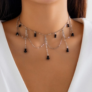 Detail of Gothic silver choker with black faceted beads and multi-layer tassels for Halloween