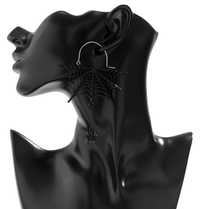 Gothic black spider web fringe earrings with silver hooks shown on a sleek dark mannequin