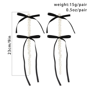 Long faux pearl tassel earrings with black silk bows measuring 23cm in length