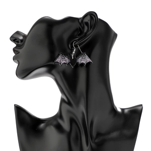 Detail of gothic bat earrings with purple mesh texture on a model stand for Halloween