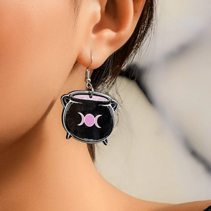 Detail of gothic witch cauldron earring with tri-phase moon symbol on ear hook