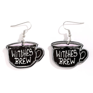 Macro detail of acrylic Witches Brew earrings with silver hooks for Halloween