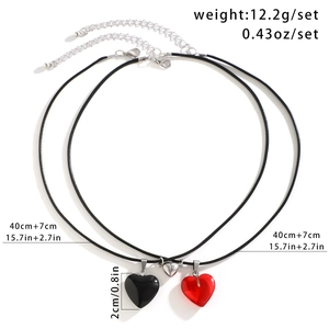Detail view of magnetic heart pendants with black wax cord and 12.2g weight specs