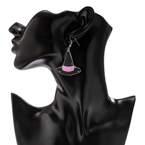 Detail of witch hat acrylic earring with pink ribbon on black display model